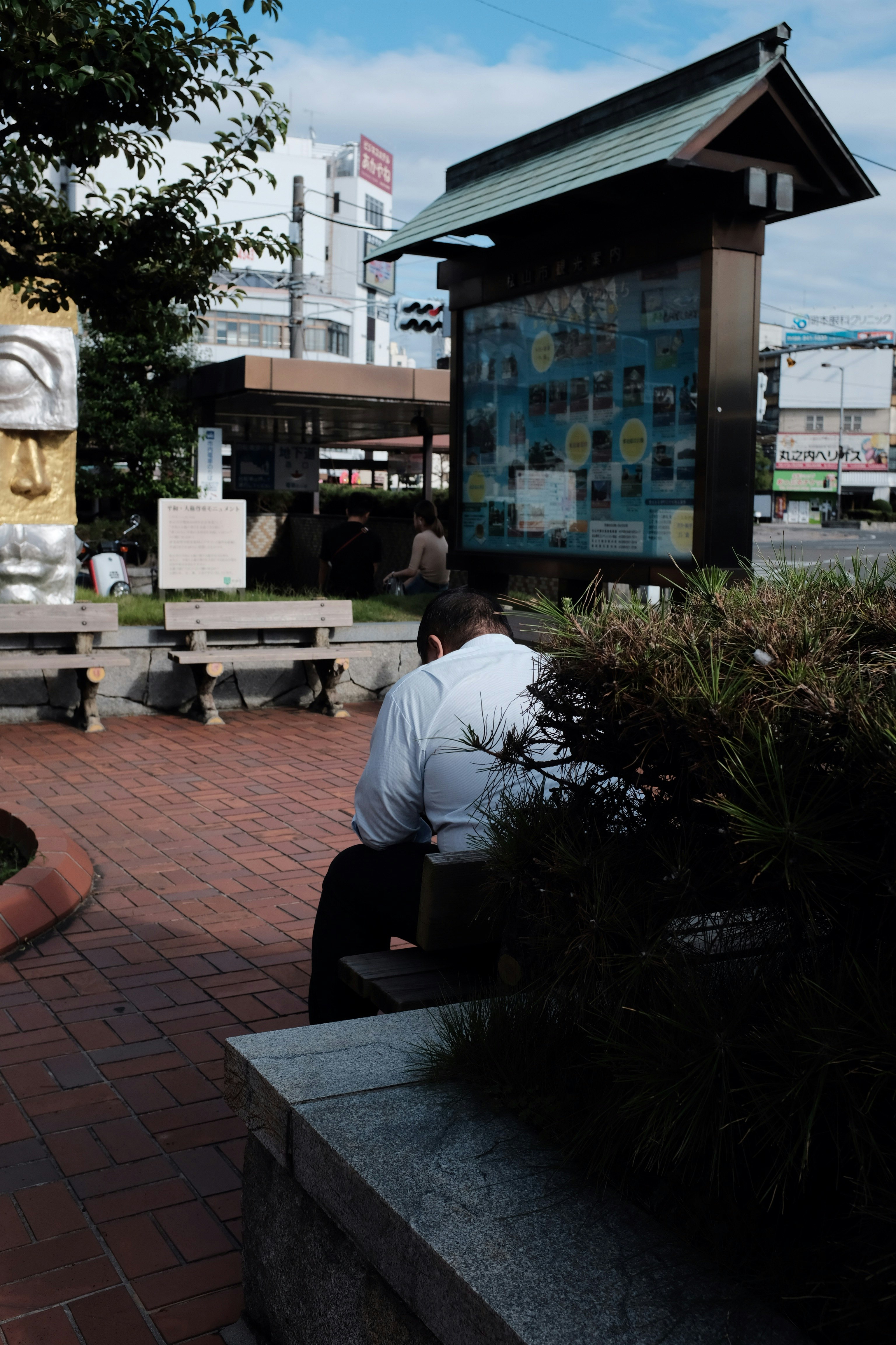 man sitting on bench during daytime